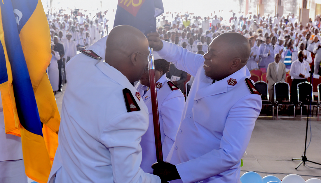 Two officers holding an Army flag.