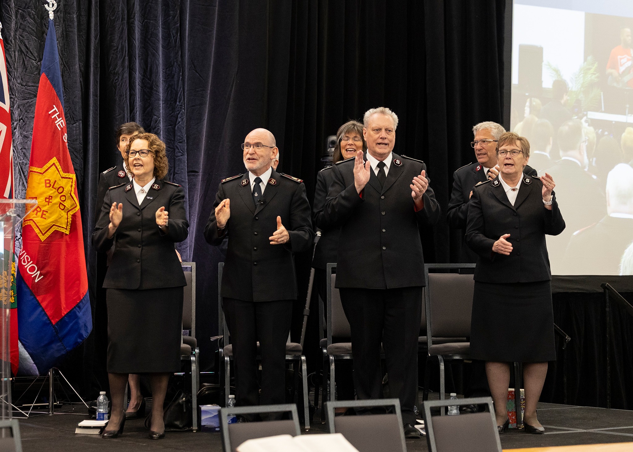 Image of General Lyndon and Commissioner Lyndon Buckingham singing with Commissioners Lee and Debbie Graves